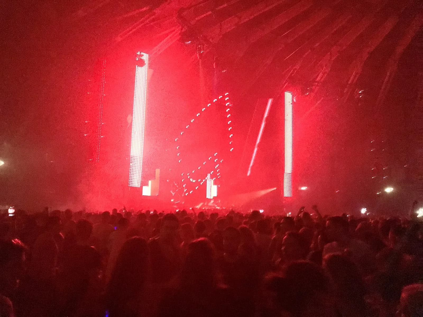 A red-lit Awakenings show with LED towers above a packed dance floor at the Gashouder in Amsterdam