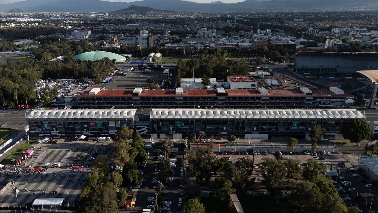 Aerial view of the Autódromo Hermanos Rodríguez grandstands with Mexico City and mountains stretching behind