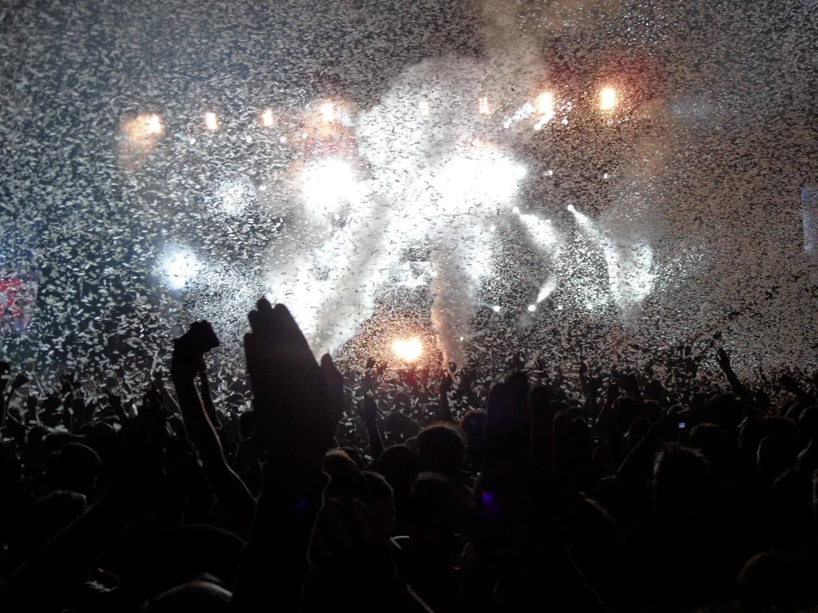 A confetti storm over the Pukkelpop night crowd, hands in the air