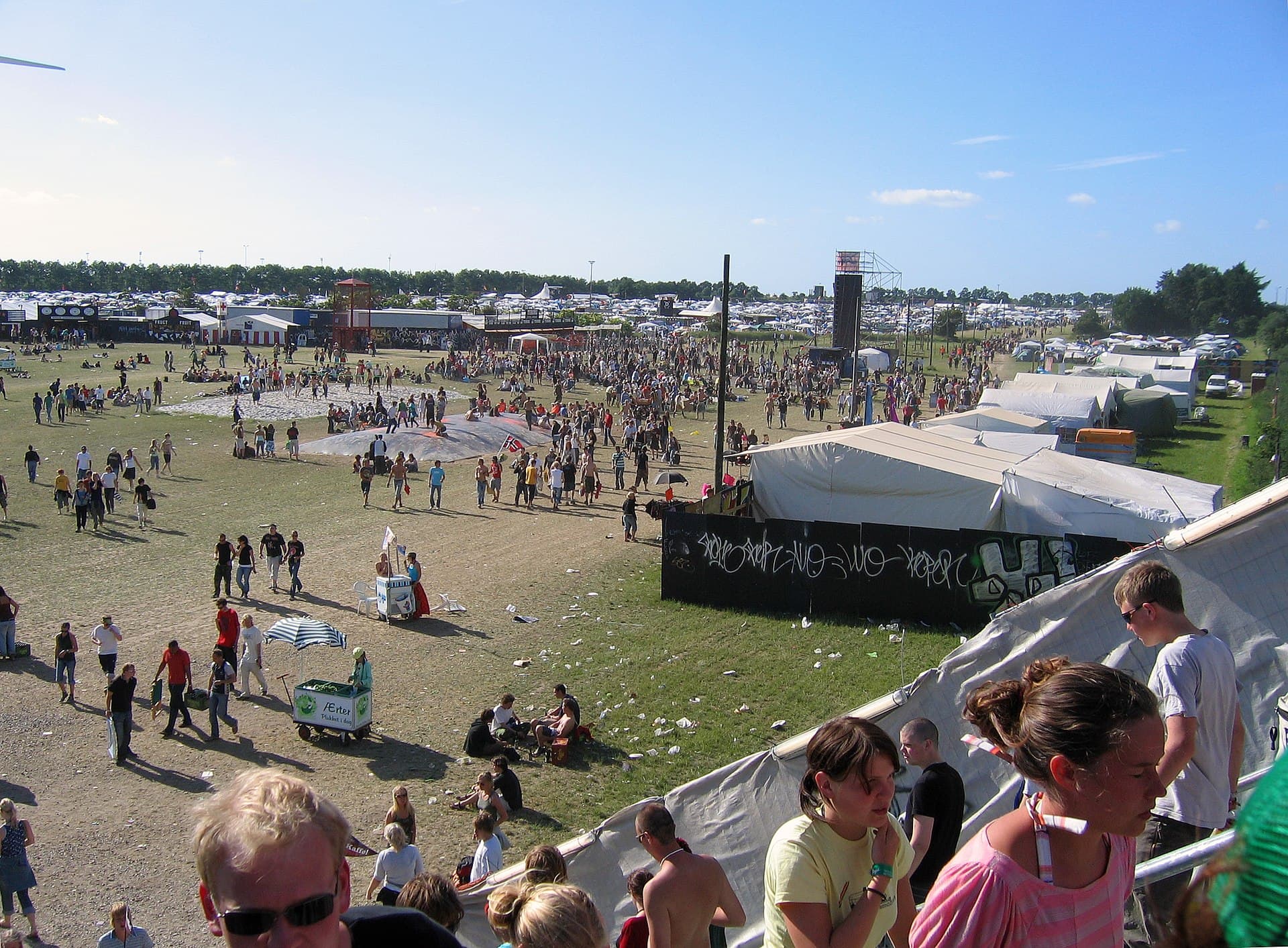 Roskilde Festival camping area with tents and festival-goers in daylight