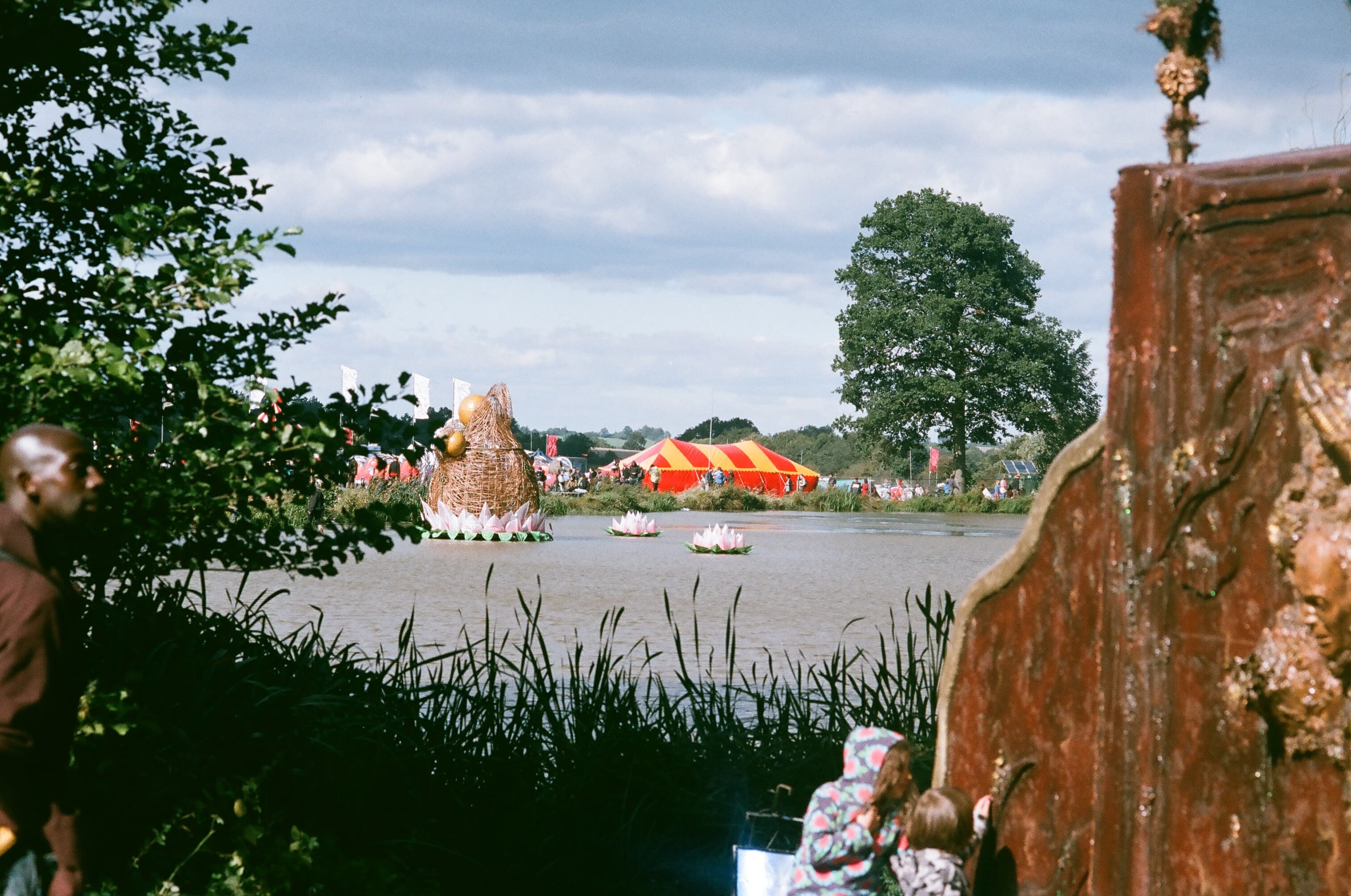 Tents across the water at Shambala Festival