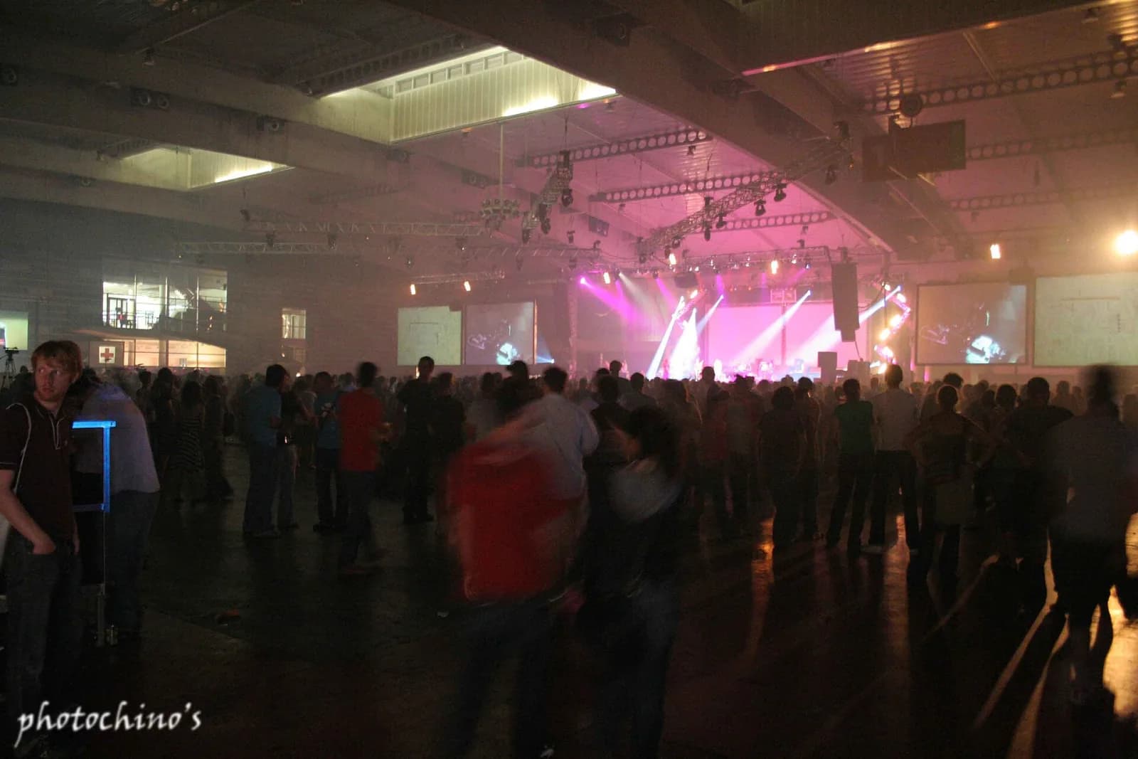 A vast night hall at Sonar with pink lights and haze over the dance floor