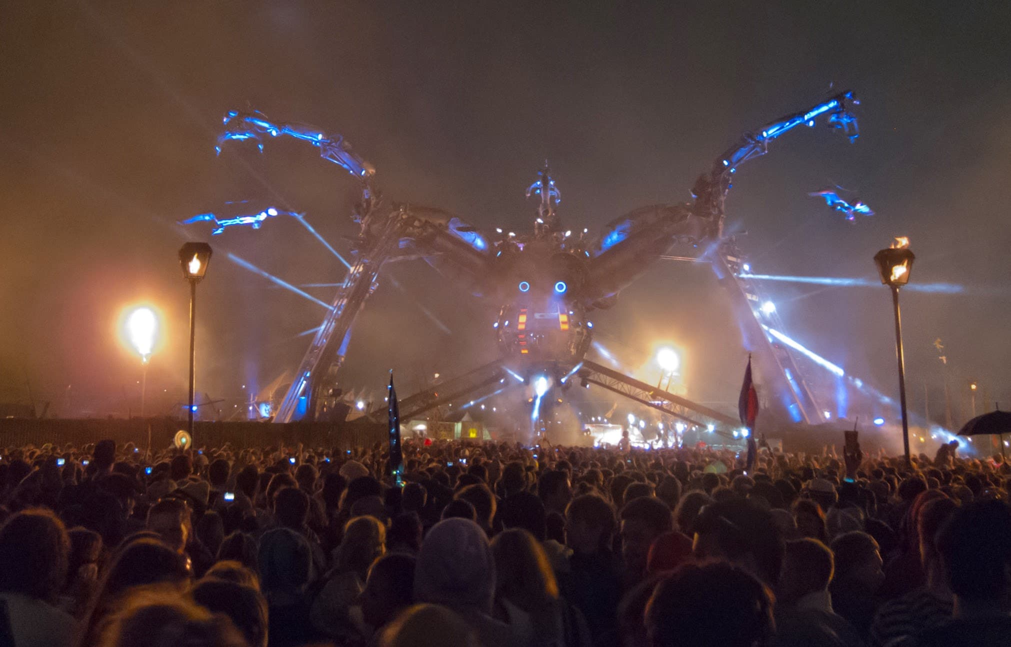 Arcadia stage at Glastonbury glowing blue above a night-time crowd